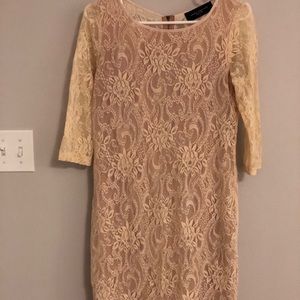 Nude lace dress with pink lining.